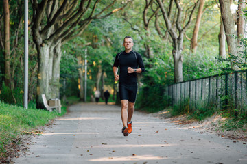 Athlete young man running in park.
