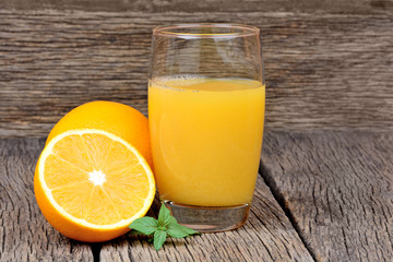 Orange juice in a glass on wooden background