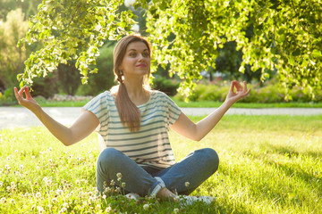 Relaxed young woman practicing yoga