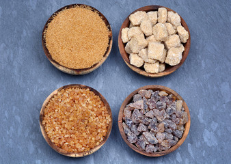 Various kinds of sugar in a bowls on slate