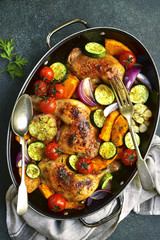 Chicken legs roasted with vegetables.Top view.