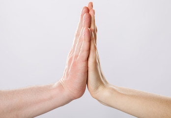 Two hands giving high five to each other