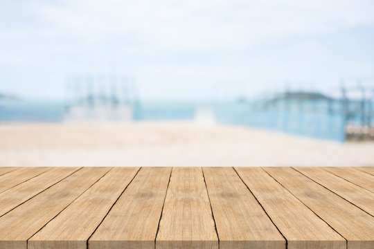 Empty wooden table in front with blurred background at the beach,space for montage you products