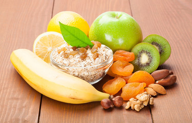 Fresh fruits, oat flakes and nuts for healthy breakfast