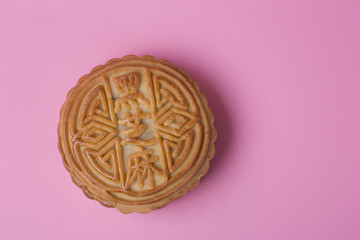 Single mooncake on the pink background. Chinese traditional food. Chinese mid autumn festival.