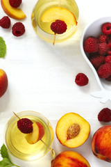 Peach wine and fruits on white wooden table, top view