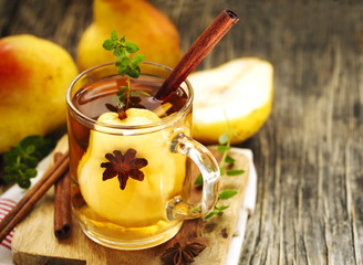 Pear punch with spices in glass cup