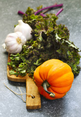 Autumn harvest vegetables. Pumpkin, kale and garlic