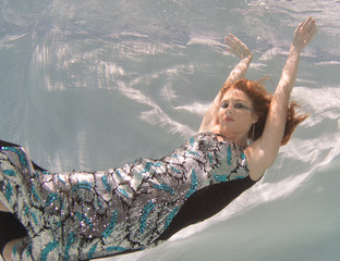 Woman with red hair in a swimming pool.