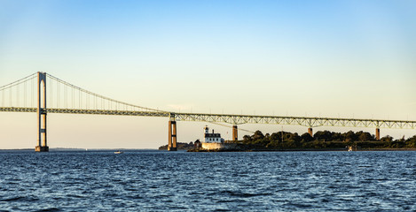 Newport Bridge with lighthouse in sunset