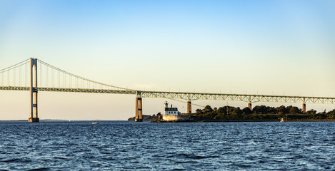 Fototapeta premium Newport Bridge with lighthouse in sunset