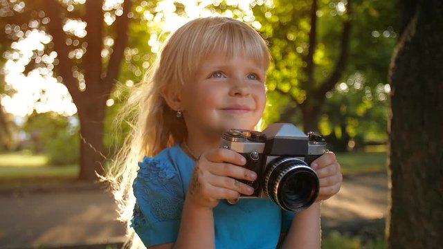 Little girl with retro camera