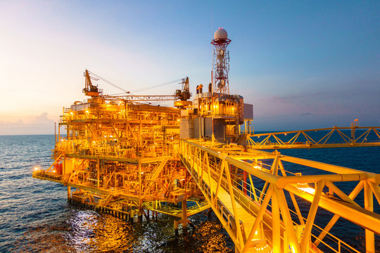 Offshore Construction Platform For Production Oil And Gas With Bridge In Evening Time