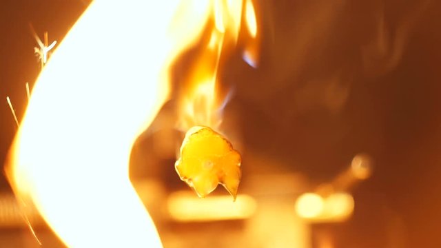 Closeup Bitcoin Burns and Falls down Like Exchange Rates