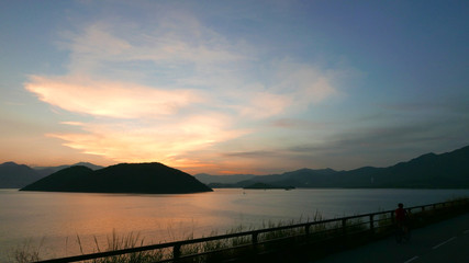 The silhouette of plant, road and frame with gradient sunset