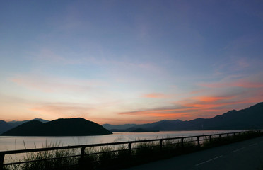 The silhouette of plant, road and frame with red cloud