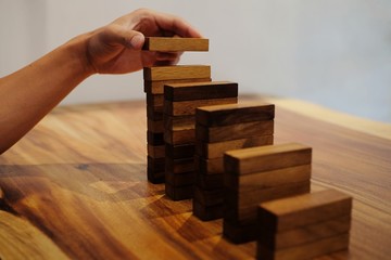 Planning risk and strategy in businessman gambling placing wooden block.Business concept for growth success process