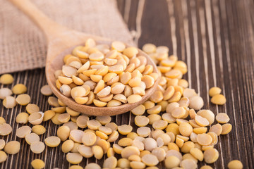 Peeled yellow soybean on brown wooden board