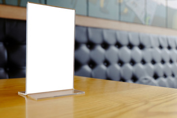 Mock up Menu frame standing on wood table in Bar restaurant cafe. space for text.