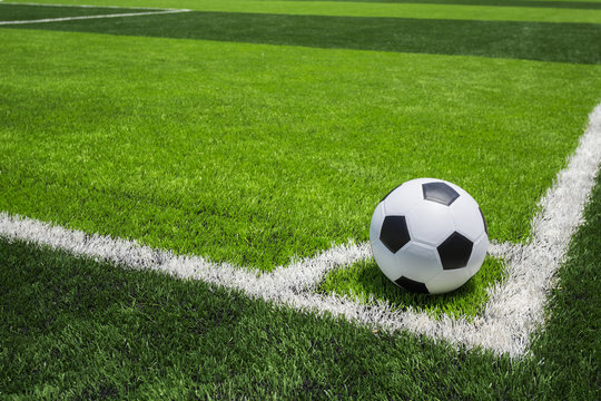 Soccer Ball On Artificial Bright And Dark Green Grass At Public Outdoor Football Or Futsal Stadium