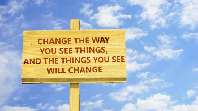 Change the way you see things and the things you see will change. Words on a wooden sign against time lapse clouds in the blue sky. 