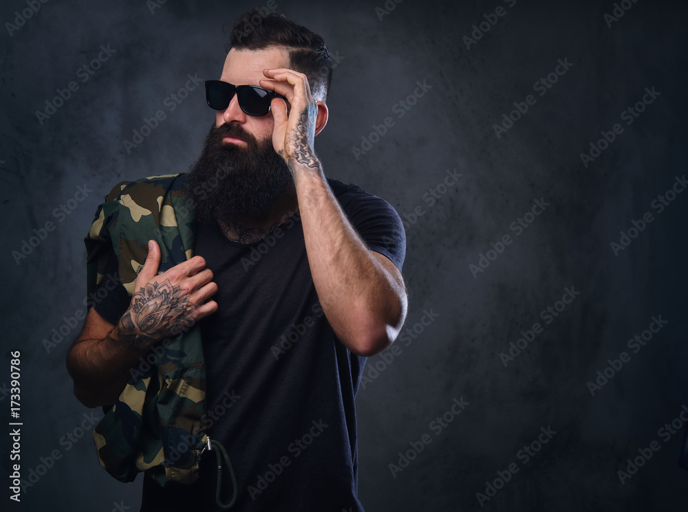 Sticker A man dressed in a camouflage jacket over grey background.