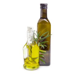 Two different bottles of olive oil with olive branch