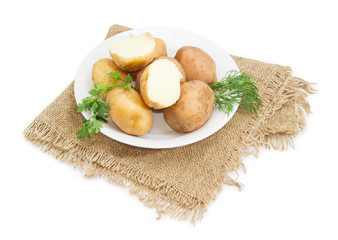 Potatoes boiled in their skins decorated with herbs on dish