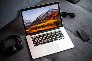 MacBook Pro lifestyle photo with glasses, headphones