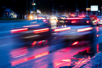 Fototapeta na wymiar blurred view of city traffic. cars driving on wet road. fast speed. 