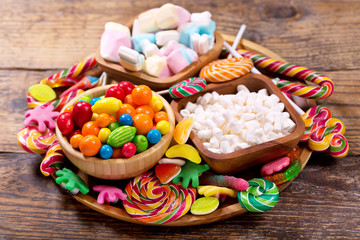Various colorful candies, jellies, lollipops, marshmallows and marmalade