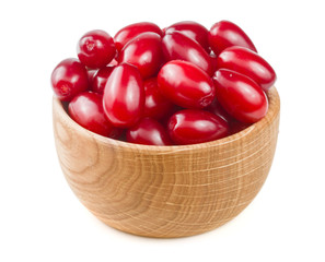 dogwood berry in a wooden bowl isolated on white background