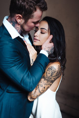 Beautiful, young couple posing on camera indoors