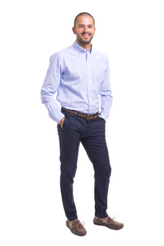Young business man standing with hands in pockets on a white background