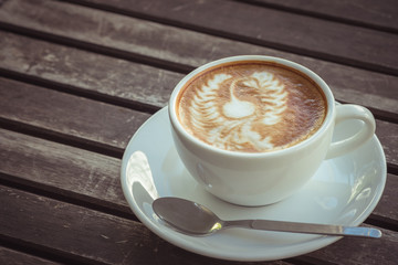 Cup of coffee art on old wooden table