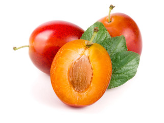 red plums end half with leaves isolated on white background