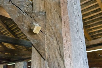 Securing two beams in the interior of the barn.