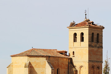 Storks' nests on the top of an old bell tower in Segovia, Spain 