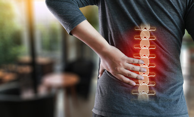 young man Feeling suffering  Lower back pain  Pain relief concept