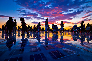 People silhouette on colorful sunset in Zadar