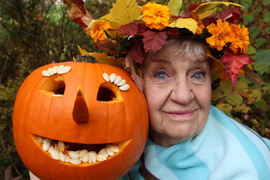 old happy woman with a pumpkin