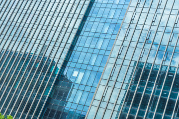 Clouds reflected in windows of modern office building.