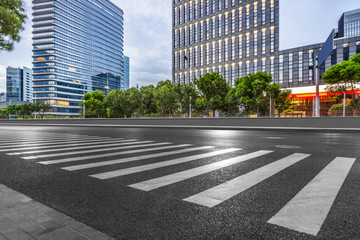 empty road with zebra crossing and skyscrapers in modern city.