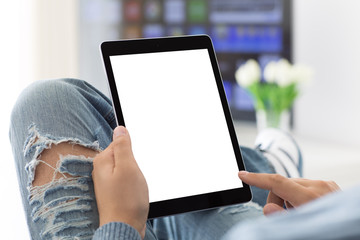 man in jeans holding tablet with isolated screen in room