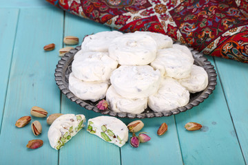 Traditional Iranian and Persian pieces of white nougat dessert sweet candies (Gaz) with Pistachio...