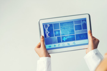 Close of female doctor hands working with tablet pc computer