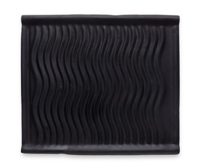 Empty rustic black stone plate with wavy texture isolated on white background
