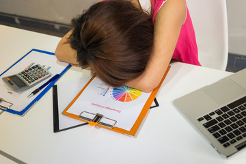 Tired employee sleeping in office after working hard