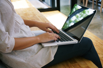 The Casual business woman works online on laptop which hand on keyboard in her house Isolated screen in laptop.