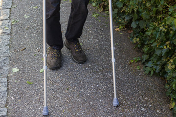 an invalid person  with his crutches